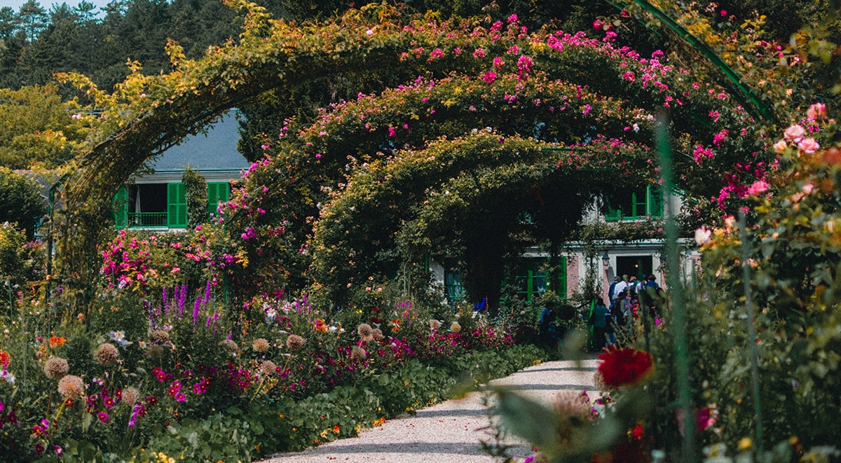 Climbing rose bushes on the arbors in front of Claude Monet’s home in Giverny, called Le Clos Normand
