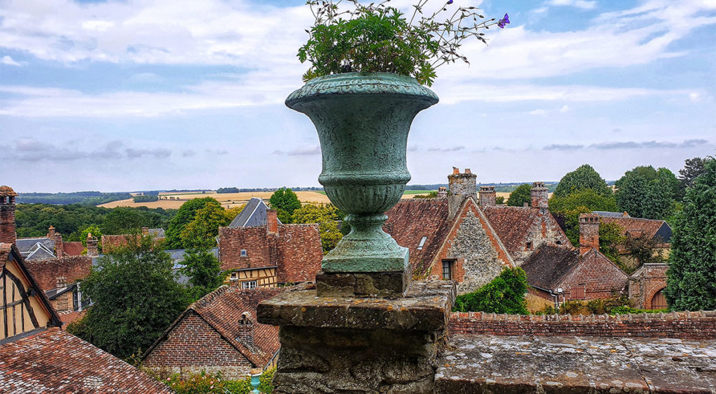 Urn over-looking roofs of Gerberoy with farms of the Bray countryside in the distance