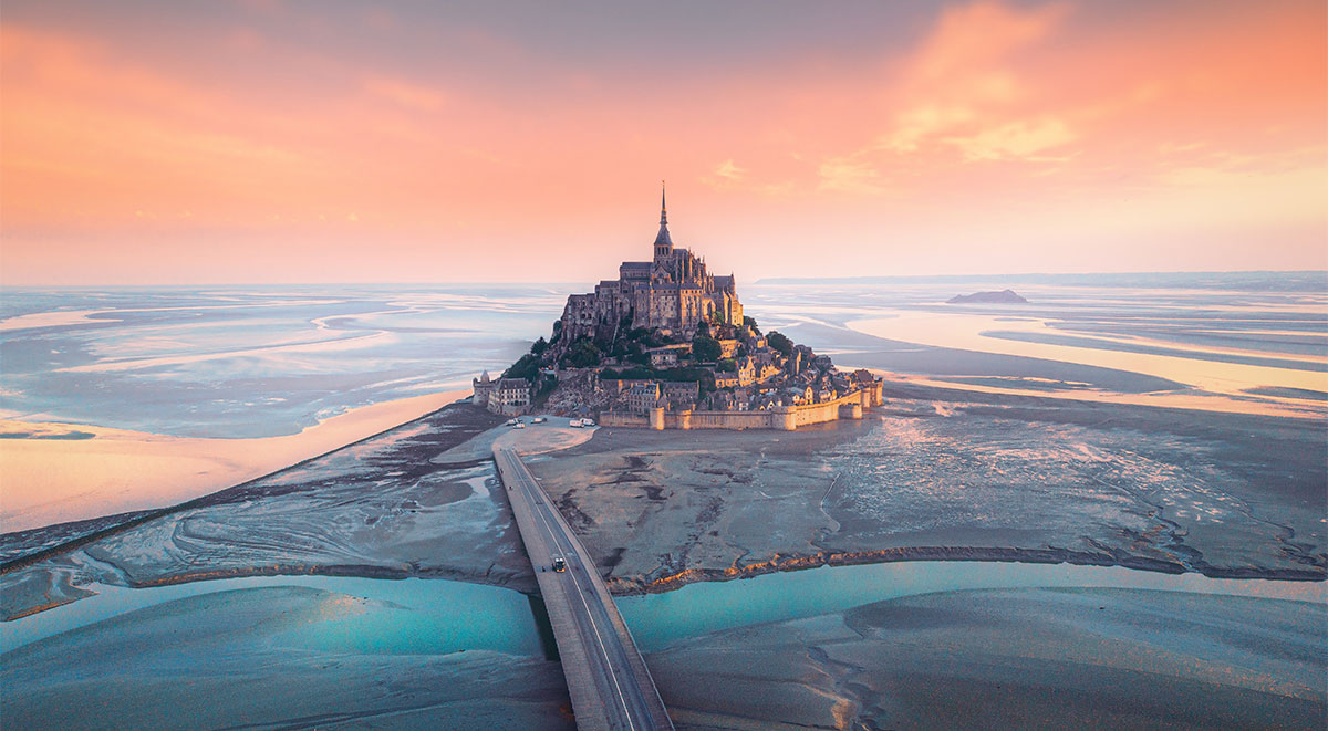 A bridge has replaced the causeway at Mont Saint Michel, allowing the tide to resume swirling around it