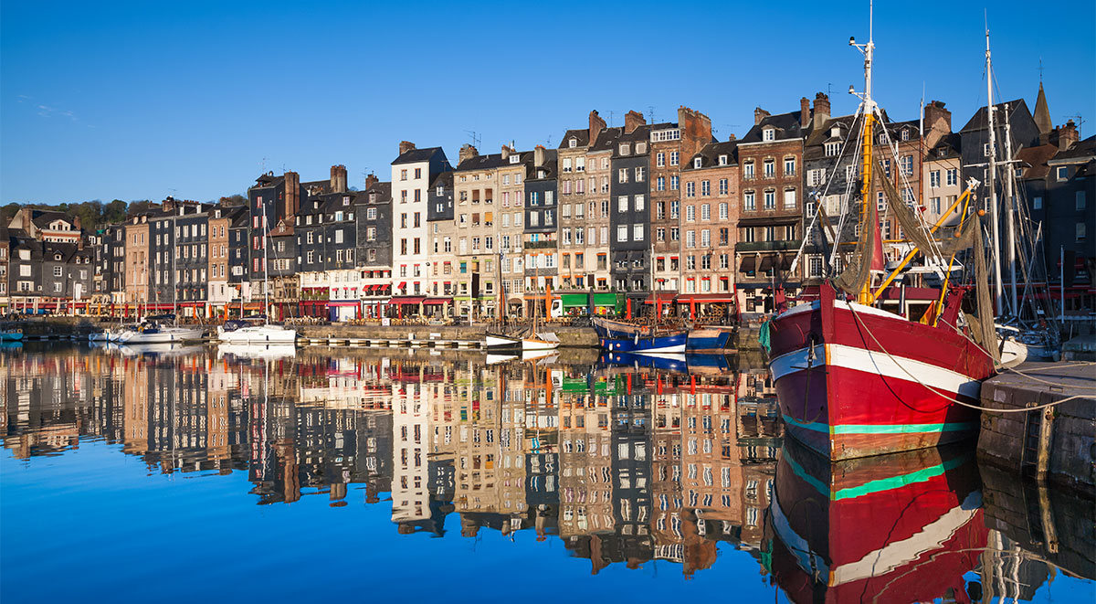 Improbably narrow seven-story structures look over the Old Port at Honfleur