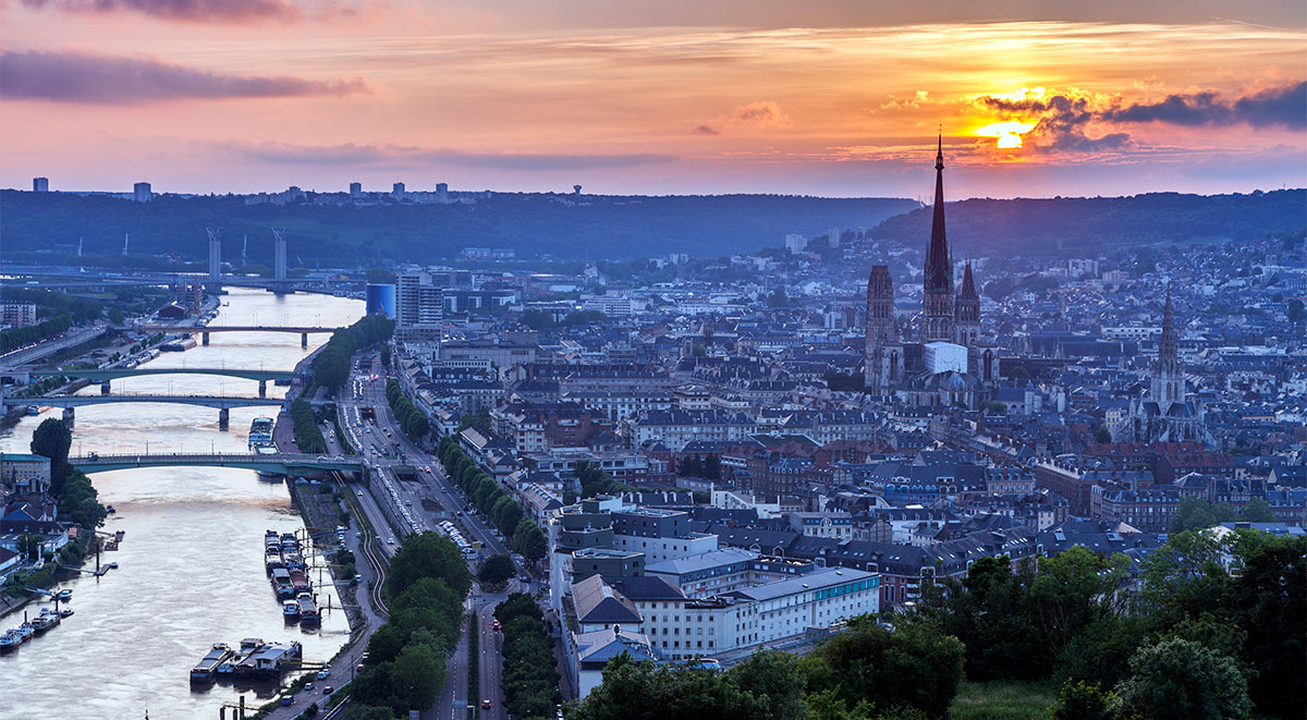Dusk settles on Rouen and Notre Dame de Rouen Cathedral with the St. Maclou church to its right